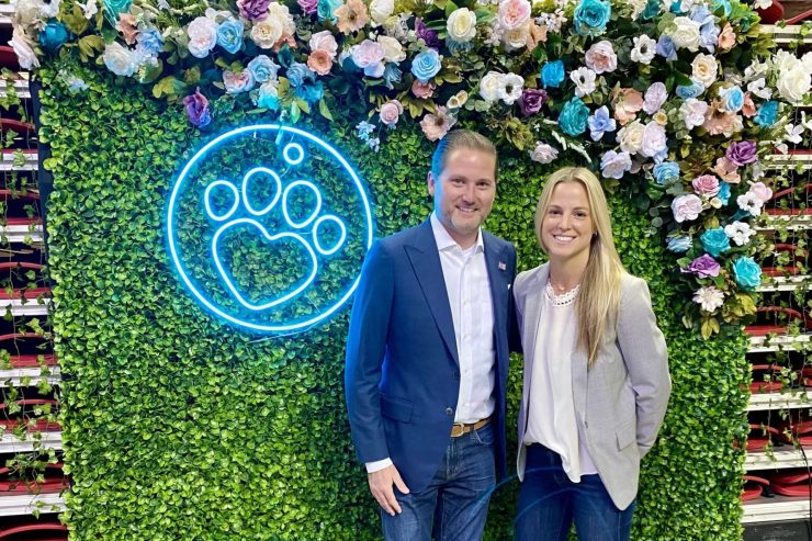 Confident professionals stand together against a vibrant floral backdrop, embodying care and advocacy.