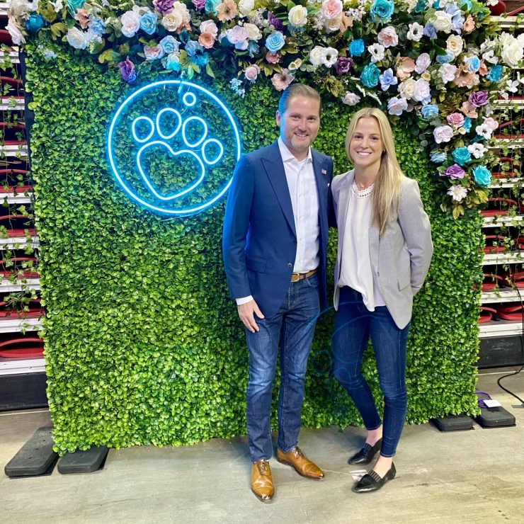 Confident professionals stand together against a vibrant floral backdrop, embodying care and advocacy.