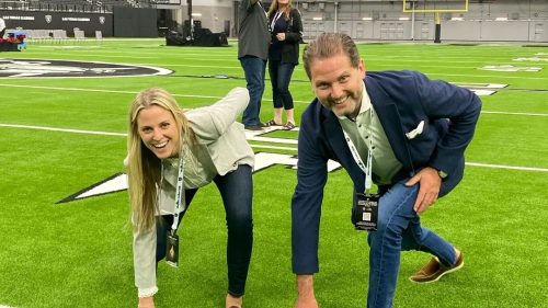 A lively group on a vibrant field conveys teamwork and celebration, reflecting community and support.