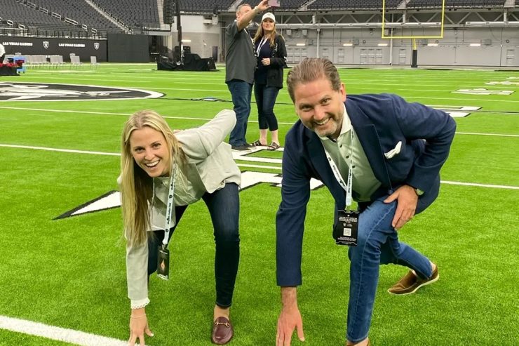 A lively group on a vibrant field conveys teamwork and celebration, reflecting community and support.