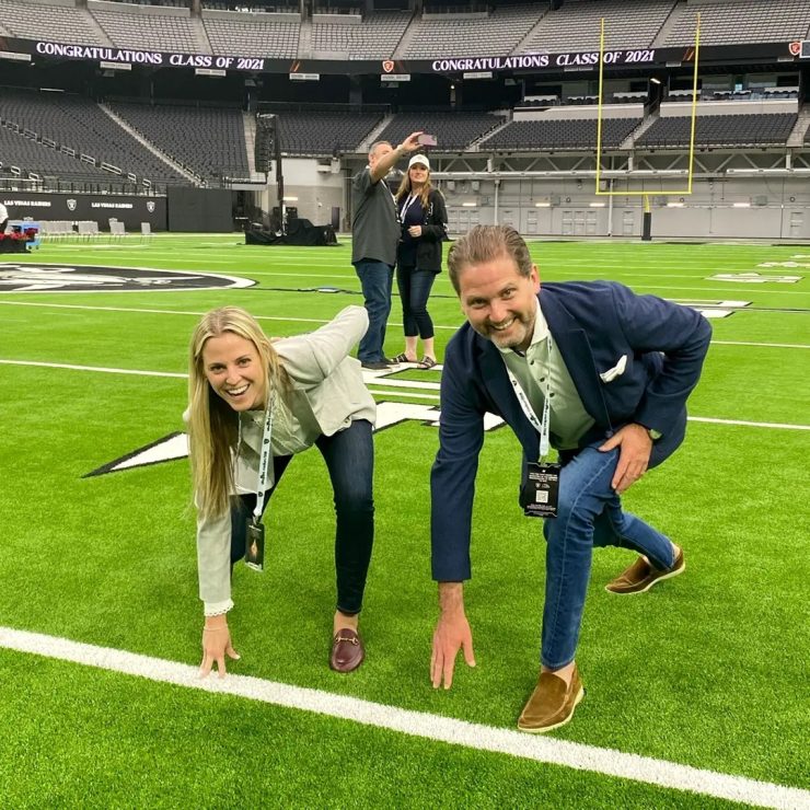 A lively group on a vibrant field conveys teamwork and celebration, reflecting community and support.