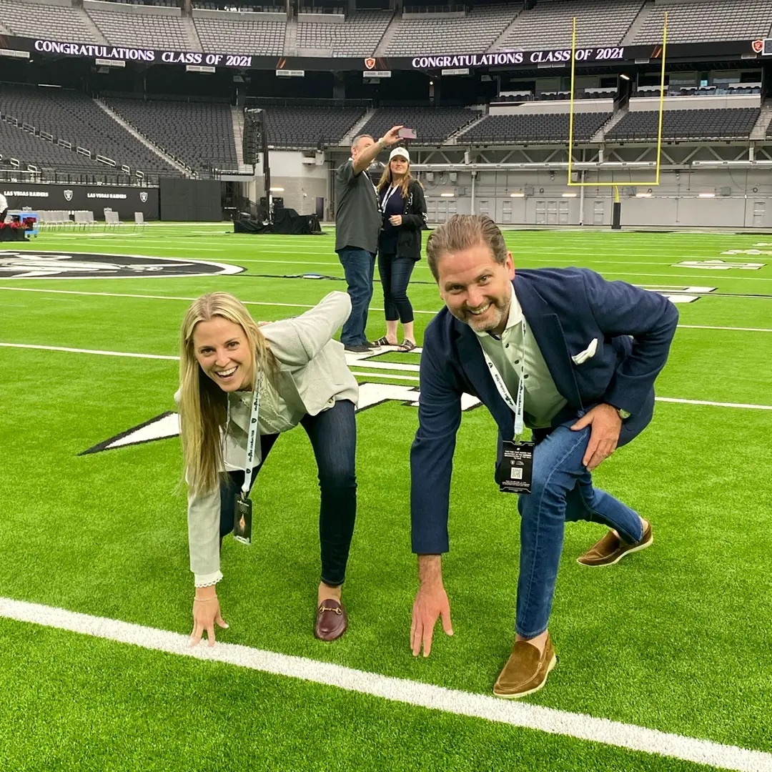 A lively group on a vibrant field conveys teamwork and celebration, reflecting community and support.