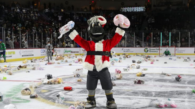 A festive mascot celebrates amidst a sea of donations, embodying community spirit and joy.