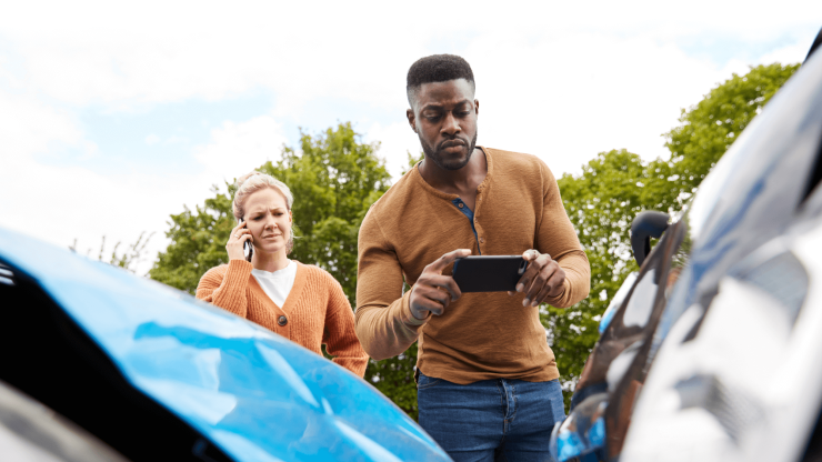 A concerned couple assesses the aftermath of a car accident, emphasizing care and support.