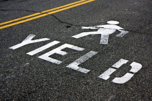 yield to pedestrians painted on street