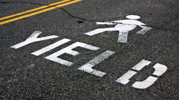 yield to pedestrians painted on street