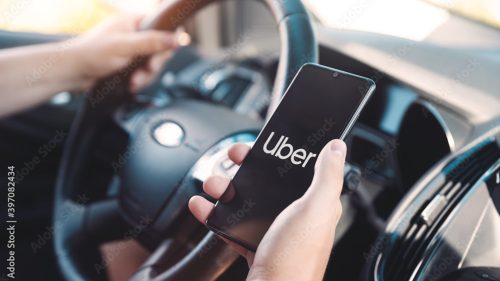 person with the uber app opened on their phone