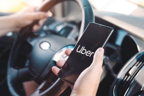 person with the uber app opened on their phone