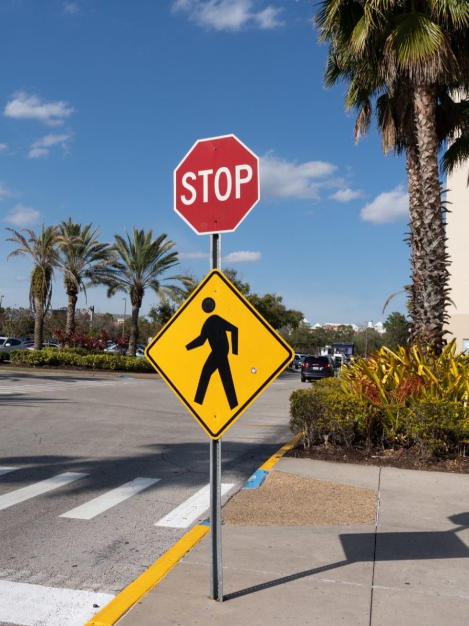 stop sign and pedestrians crossing sign