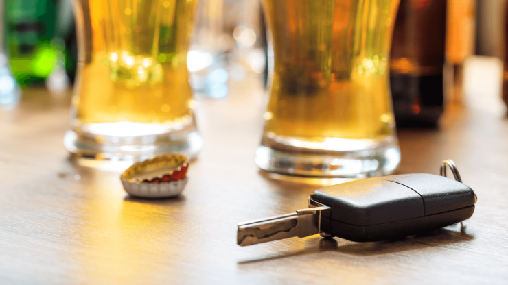 A key rests on a table near drinks, highlighting the importance of safe choices and responsibility.