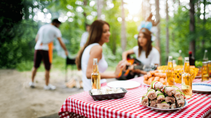 A lively outdoor gathering, showcasing camaraderie and care, with delicious food and cheerful company.