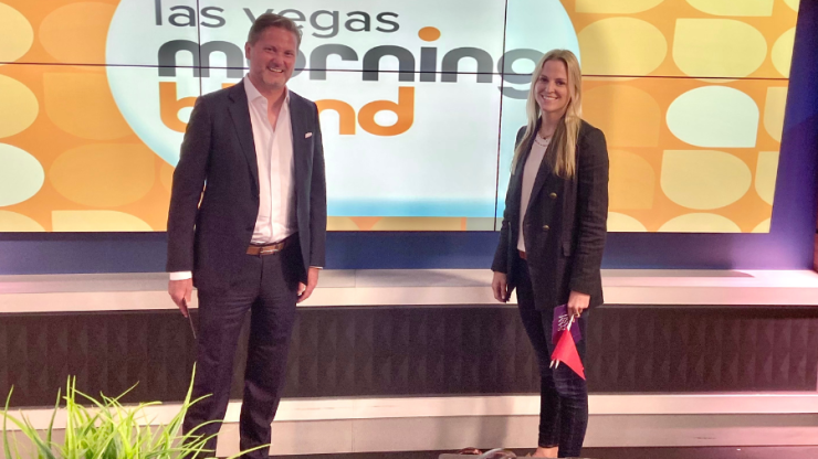 Two professionals stand confidently in a bright studio, embodying advocacy and expertise.