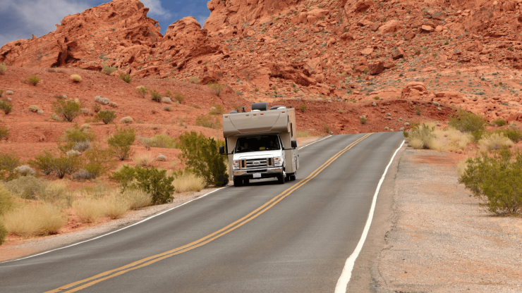 A serene road winds through stunning red rock formations, evoking adventure and safety.