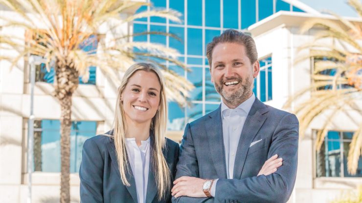 Confident attorneys stand together outside a modern building, exuding professionalism and approachability.