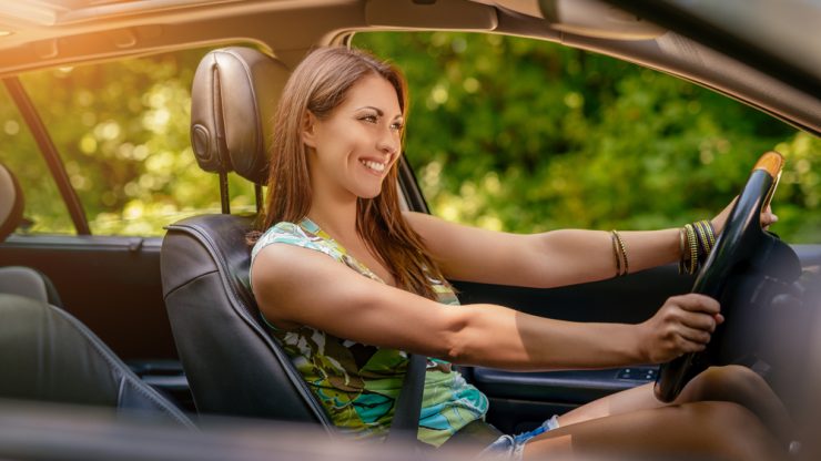 woman driving and smiling