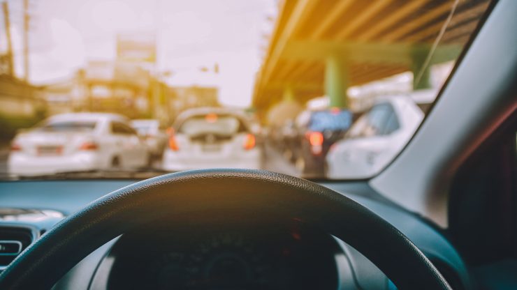 A view from the driver's seat in heavy traffic, highlighting the urgency of safe driving.
