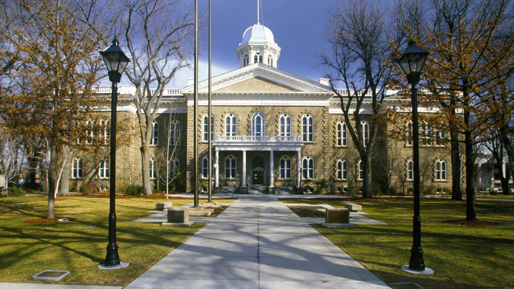 A stately courthouse stands proudly, surrounded by well-kept grounds, reflecting justice and advocacy.