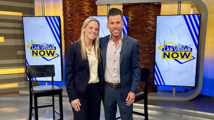 Two professionals stand confidently in a modern studio, exuding warmth and approachability.