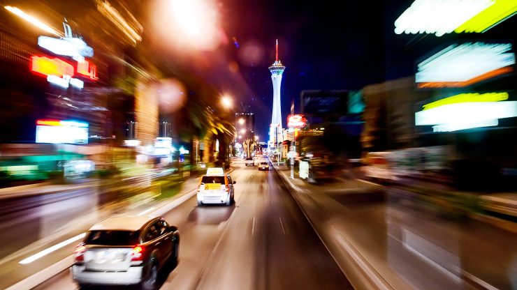 Dynamic city scene at night, highlighting urgency and the vibrancy of life, reflecting advocacy.