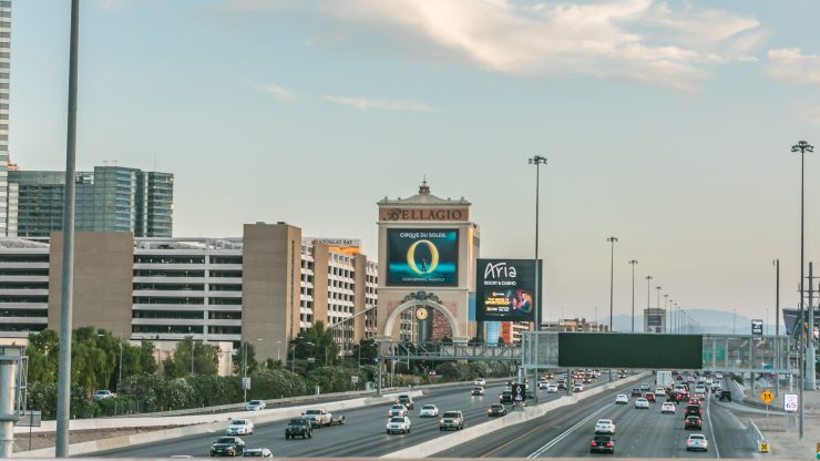 A vibrant Las Vegas scene, showcasing iconic landmarks and bustling traffic, embodies energy and resilience.