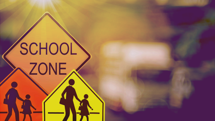 School zone signs emphasize safety and community care, highlighting the importance of vigilant driving.