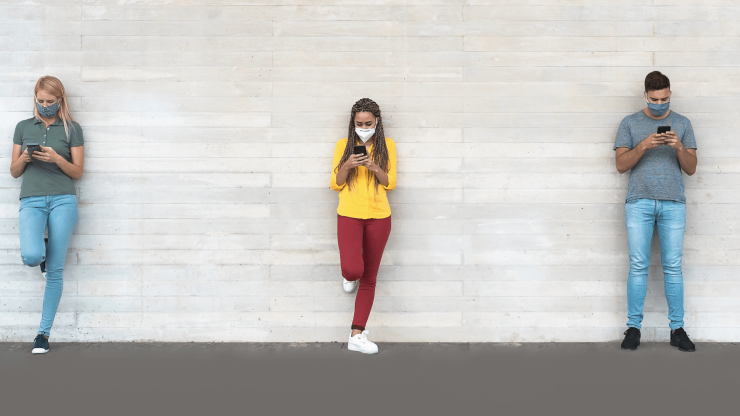 Three individuals, each focused on their phones, convey a sense of connection and care.