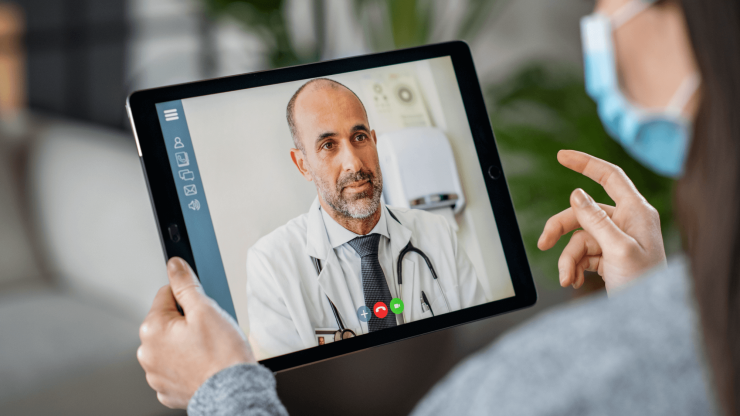 A patient engages in a virtual consultation with a caring doctor, fostering a supportive atmosphere.