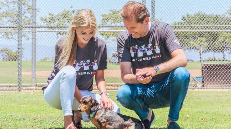 A warm, engaging moment in a park, showcasing compassion and connection with a pet.