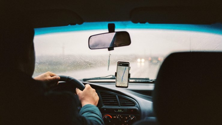 A driver navigates through rain-soaked roads, emphasizing focus and the importance of safety.