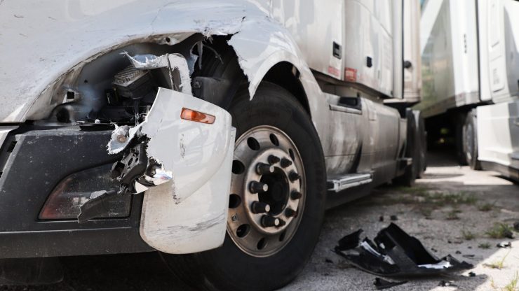 A damaged truck in a parking area reflects the seriousness of personal injury cases.