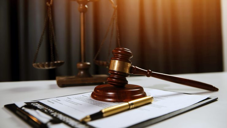 A gavel rests confidently on legal documents, symbolizing advocacy and justice in a professional setting.