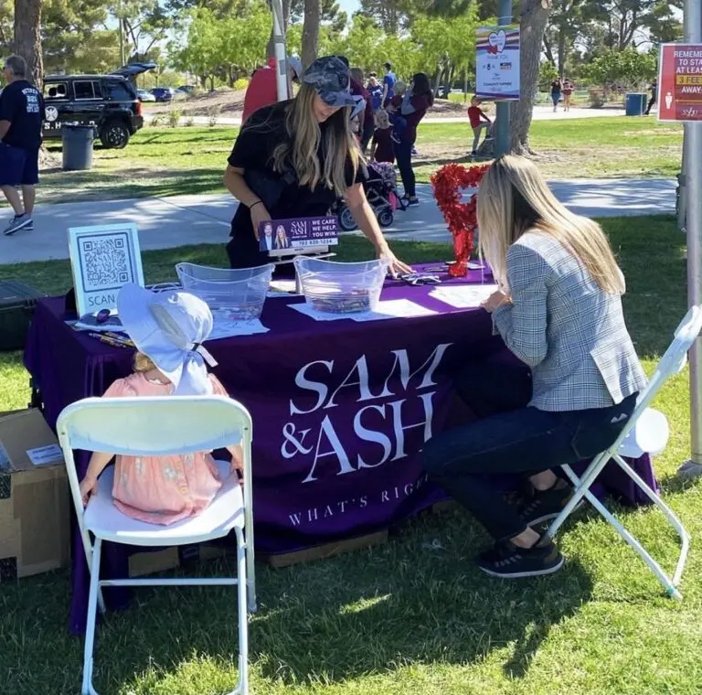 A vibrant outdoor event showcasing community engagement, with advocates ready to assist attendees.