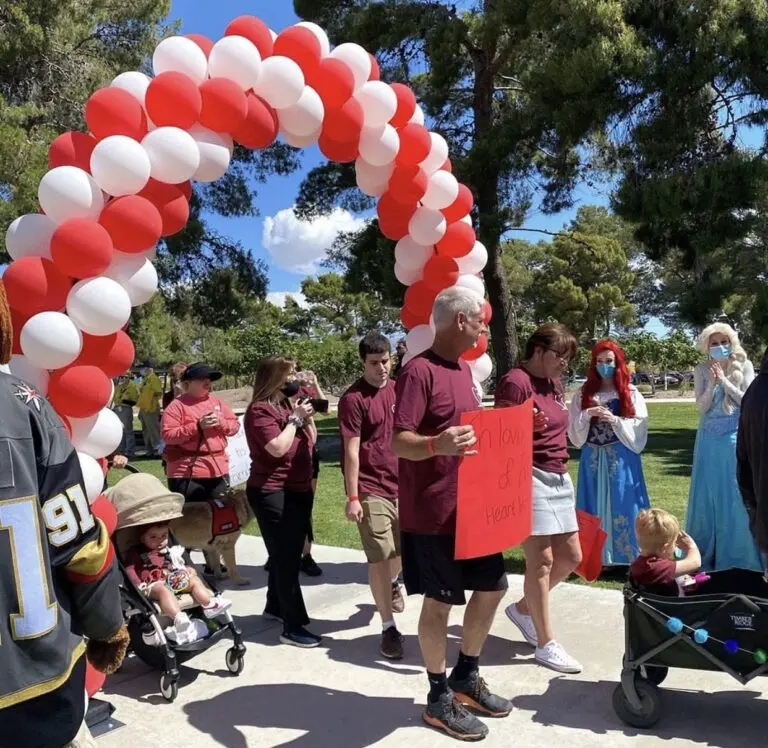 A vibrant community event showcasing unity and support, filled with families and joyful participants.