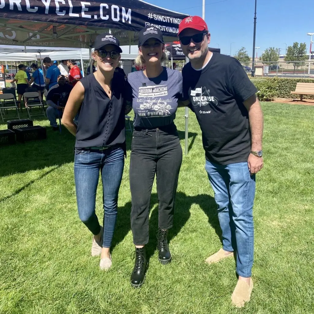 A confident team engages in a sunny outdoor setting, showcasing advocacy and community support.