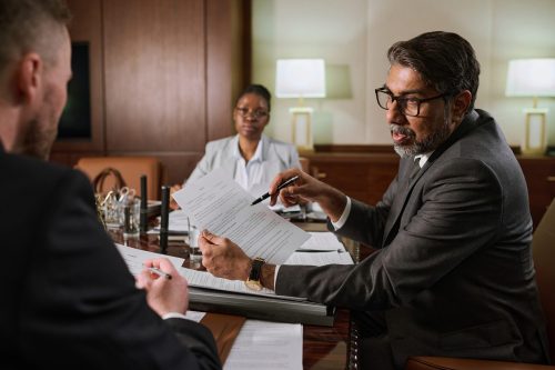 A professional discussion unfolds in a modern office, reflecting confidence and commitment to advocacy.