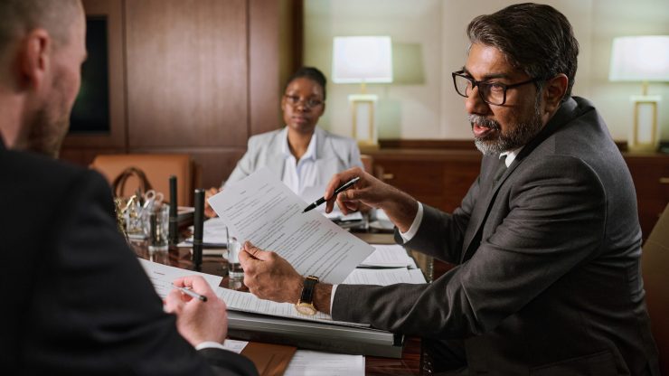 A professional discussion unfolds in a modern office, reflecting confidence and commitment to advocacy.