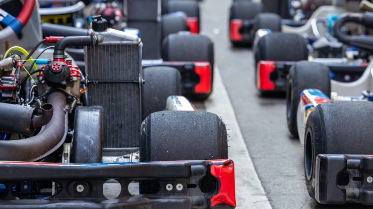 A row of meticulously maintained go-karts, showcasing precision and readiness for racing.