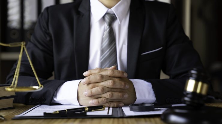 A confident attorney in formal attire conveys professionalism and commitment to justice.