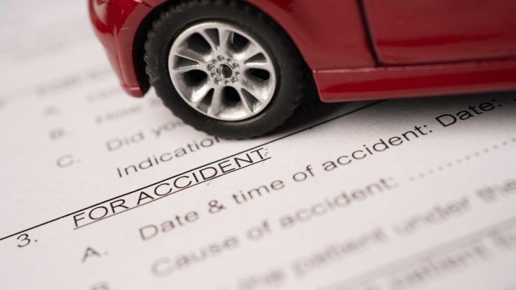A model car rests on an accident report, symbolizing diligence and advocacy for clients.