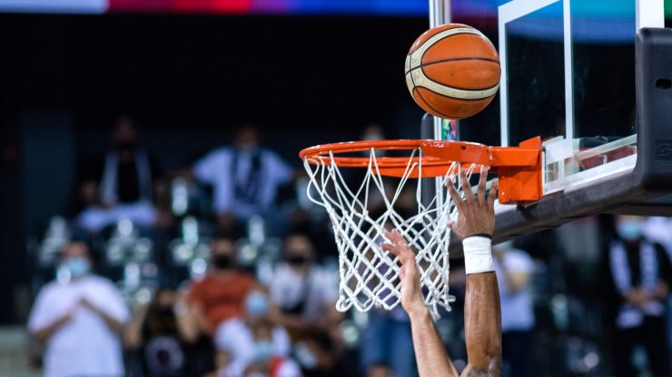 A dynamic basketball moment captures the intensity of competition, showcasing teamwork and determination.