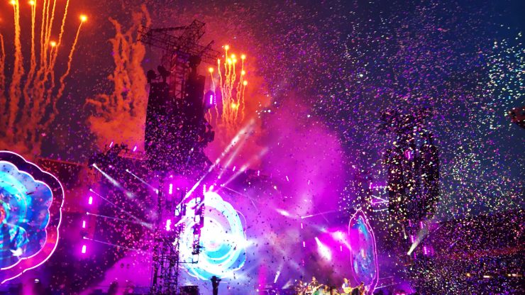 A vibrant concert scene filled with energy, confetti, and fireworks, creating an uplifting atmosphere.