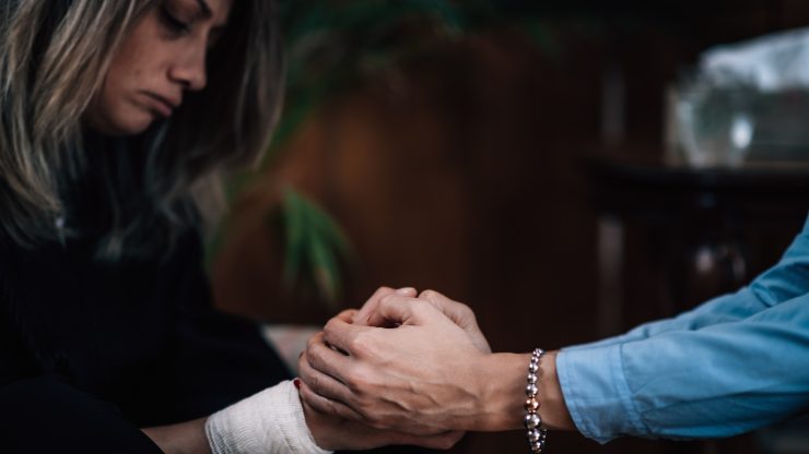 A compassionate moment of support, reflecting care and advocacy in a healing environment.