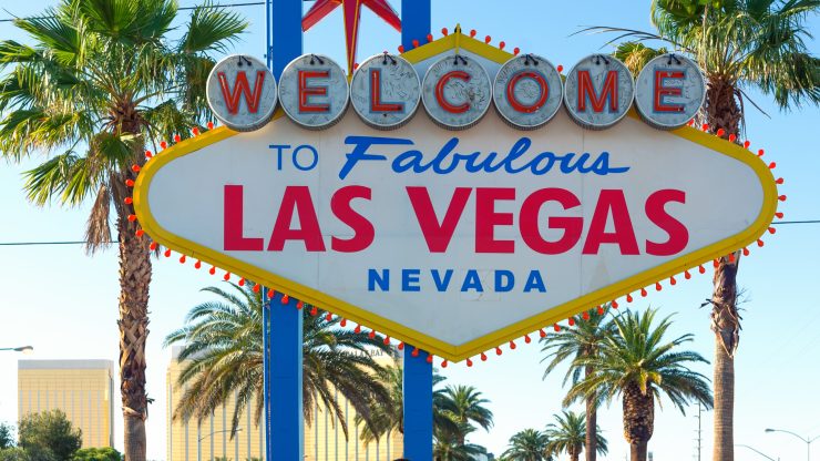 Iconic Las Vegas sign with palm trees and clear skies symbolizing strong local representation.