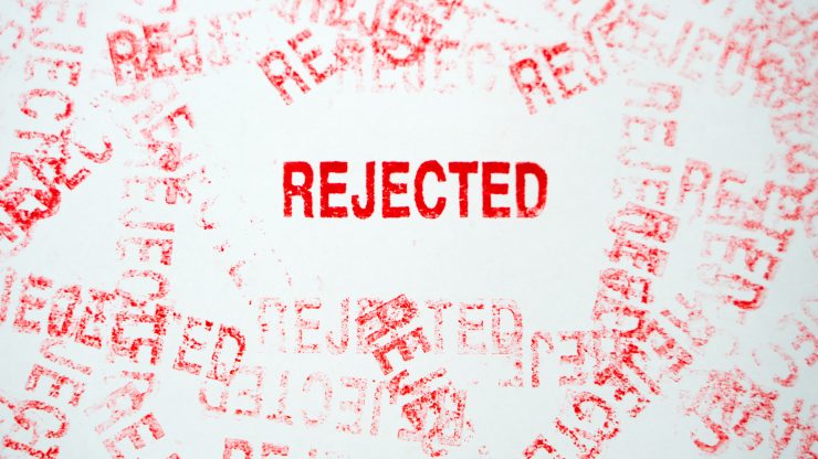 Multiple red rejected stamps on a white background symbolizing denied claims or appeals.