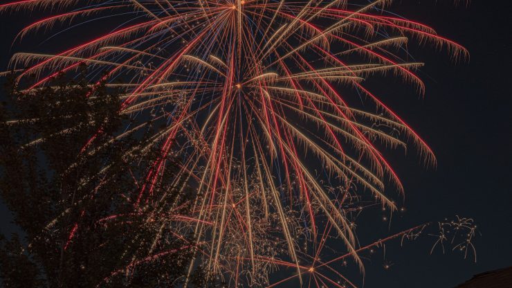 Vibrant fireworks light up the night sky in a dazzling celebration.